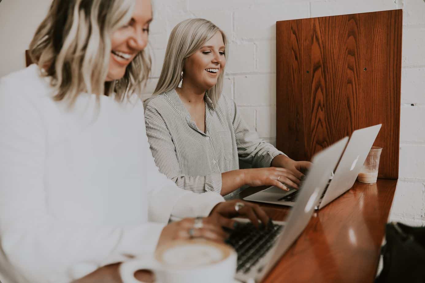 Two entrepreneurs working on a laptop to secure brand collaboration