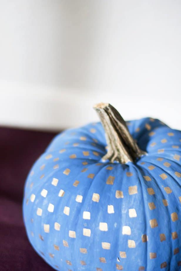 Check out these painted pumpkins you can use to decorate your home this fall on a budget? It's amazing what you can do the decorate a standard orange pumpkin. Love the metallic pattern detail!